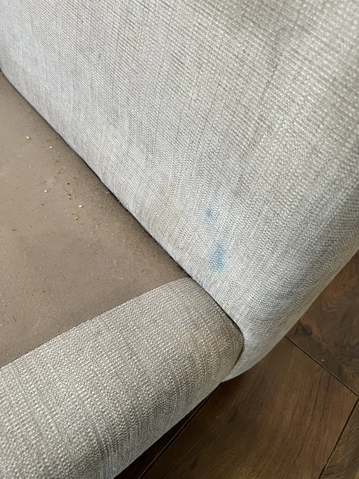 Blue ink and marker-like stains on sofa upholstery before professional cleaning