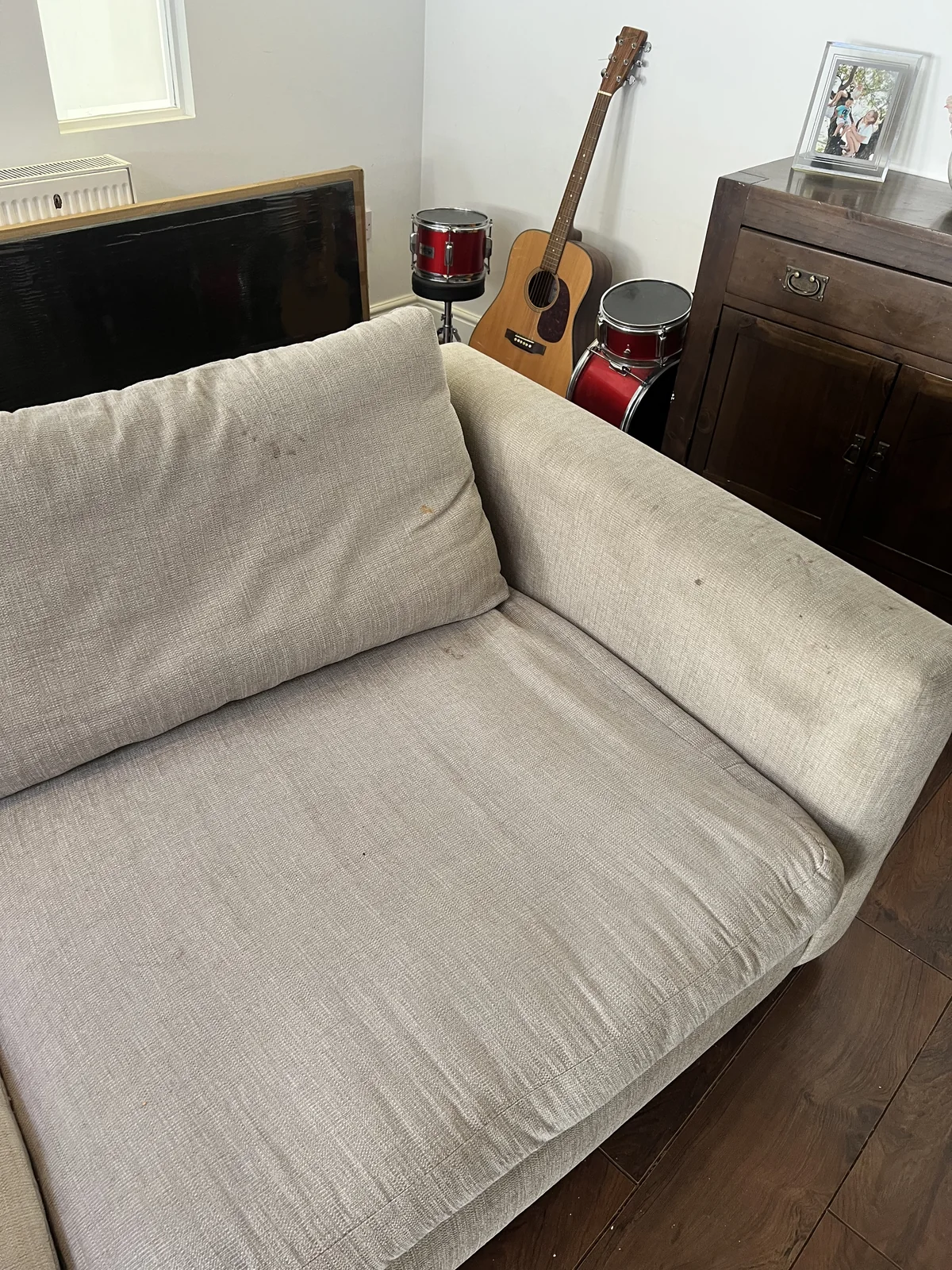 Sofa with everyday dirt and marks before professional upholstery cleaning