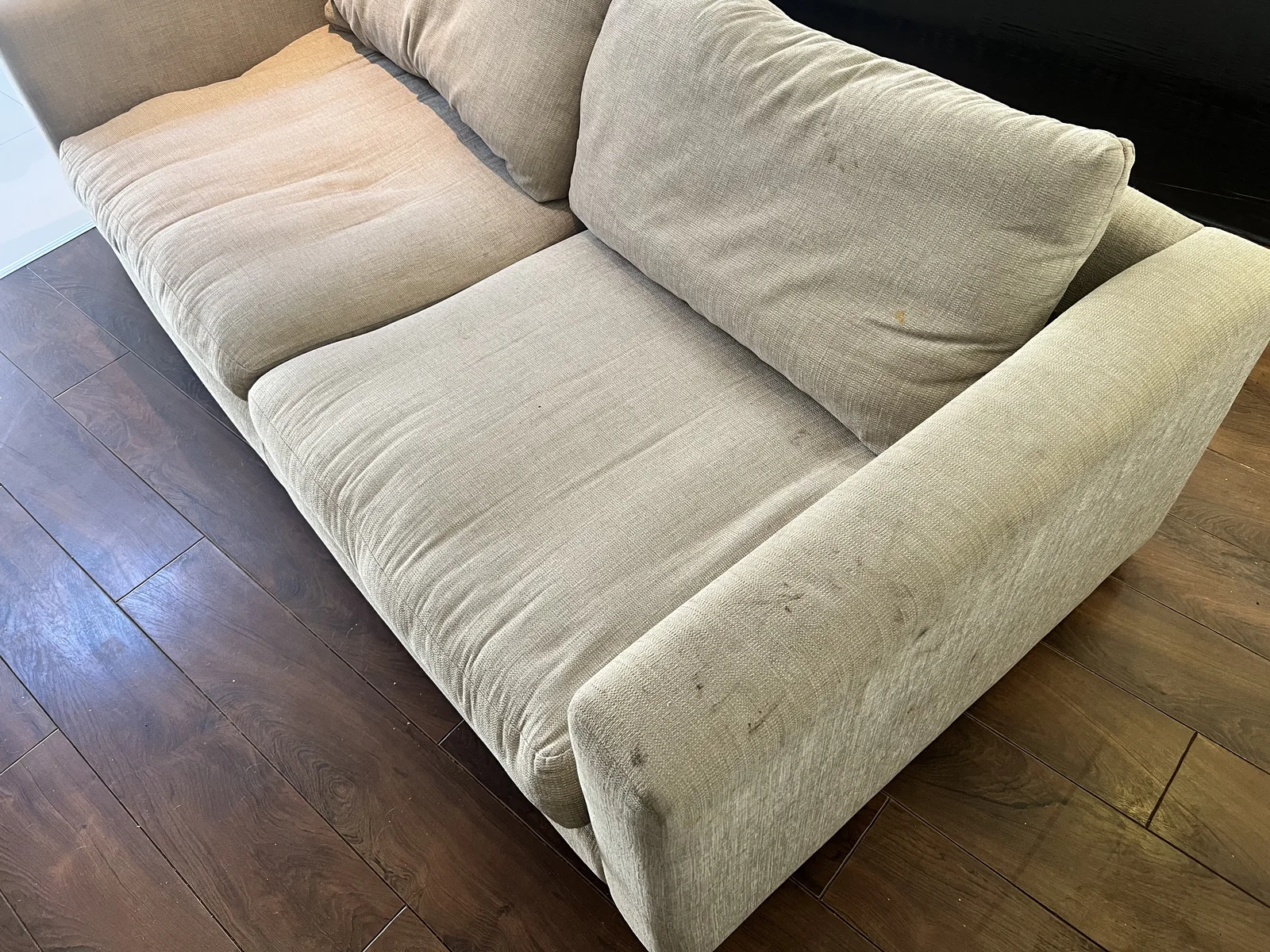 Sofa with food and sugary drink stains before professional cleaning